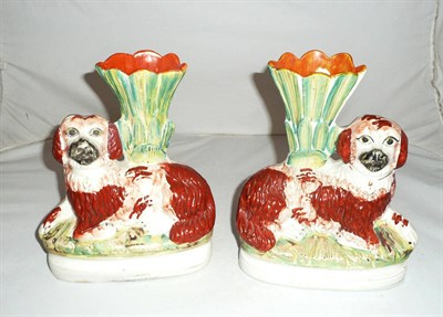 Lot 363 - A pair of Staffordshire pottery Spaniel spill vases, circa 1870, the recumbent animals with...