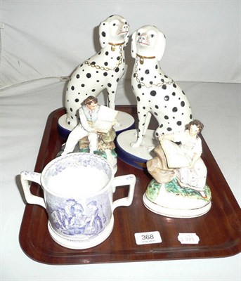 Lot 368 - A pair of seated pottery figures reading books, a 19th century two handled transfer printed mug and