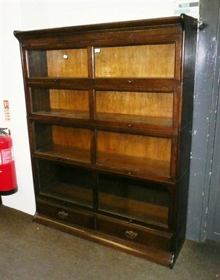 Lot 511 - An oak four tier 'Gunn' Globe Wernicke style glazed bookcase, on platform base