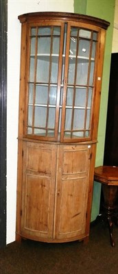 Lot 520 - A Victorian pine double bow fronted corner cabinet with glazed top