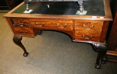 Lot 545 - An early 20th century mahogany writing table with black leather inserted top