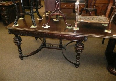 Lot 557 - Large carved oak dining table with leaf