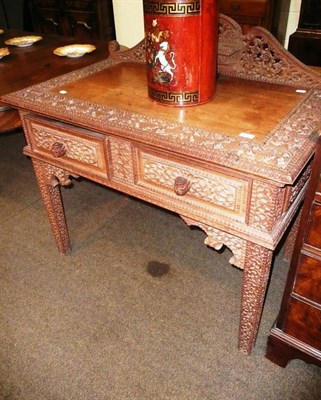 Lot 571 - An Anglo-Indian hardwood heavily carved side table