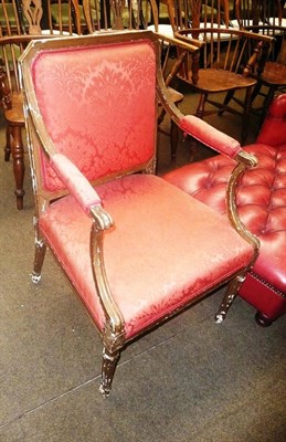 Lot 580 - Gilded open armchair in red upholstery