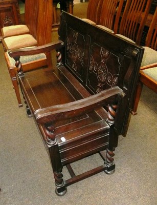 Lot 594 - An early 20th century oak monks bench on barley twist supports