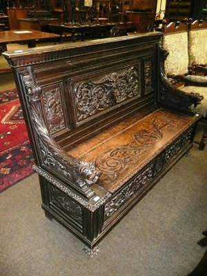 Lot 596 - A 19th century carved oak bench settle