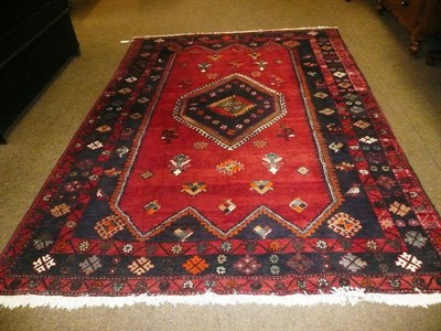 Lot 597 - A Red and Blue Ground Persian style woolen carpet