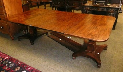 Lot 598 - A large early 19th century mahogany twin pedalled dining table with two extra leaves