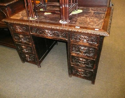 Lot 603 - A late 19th century carved oak knee hole desk