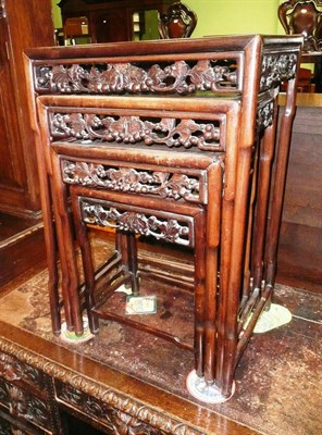 Lot 604 - A nest of four carved Chinese hardwood occasional tables (inscribed under largest table)