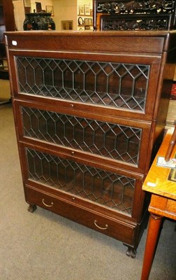 Lot 609 - A Globe Wernicke style three tier bookcase, on broad base