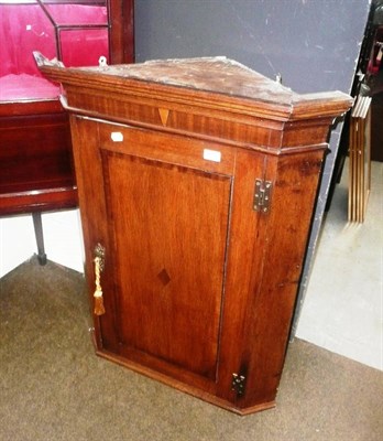 Lot 616 - George III mahogany corner cupboard