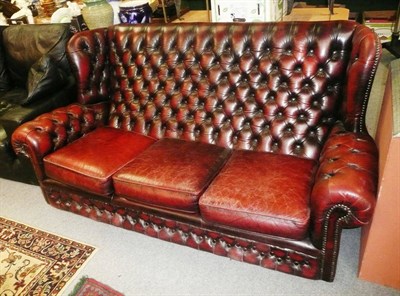 Lot 731 - Burgundy leatherette button back wing settee