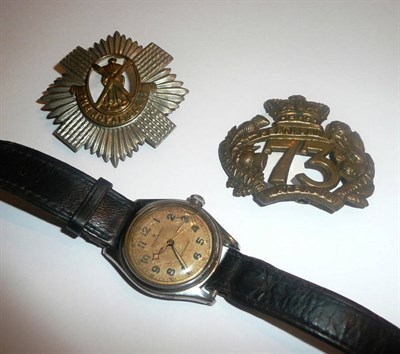 Lot 3 - A Rolex wristwatch and two cap badges