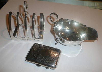 Lot 23 - A silver sauce boat, silver toast rack and a silver cigarette case, 8.3oz