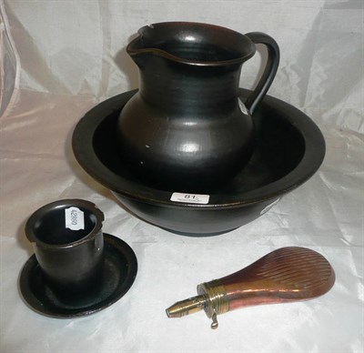 Lot 81 - A Sykes Patent copper powder flask and a black glazed wash jug, bowl, soap dish and mug
