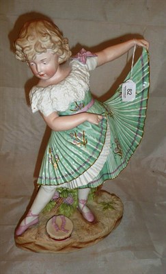 Lot 82 - A bisque figure of a young girl wearing a green dress