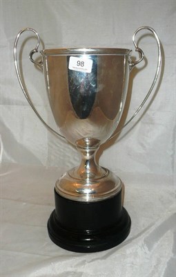 Lot 98 - A large twin-handled silver trophy cup with ebony base, 46oz