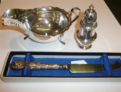 Lot 168 - A silver sauce boat, a white metal pepper pot and a silver handled cheese knife