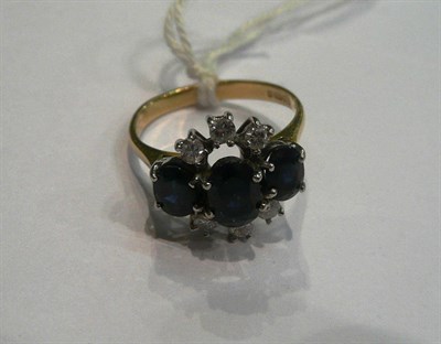 Lot 185 - A three stone sapphire and diamond ring