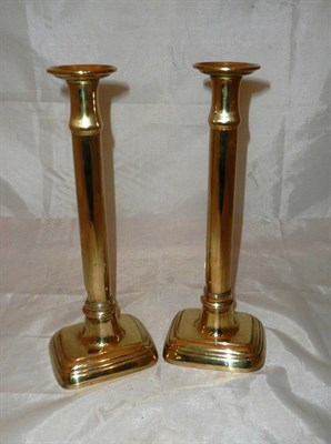 Lot 221 - A pair of early 19th century brass candlesticks