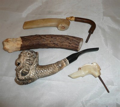 Lot 304 - Four assorted walking cane handles and a bone pipe