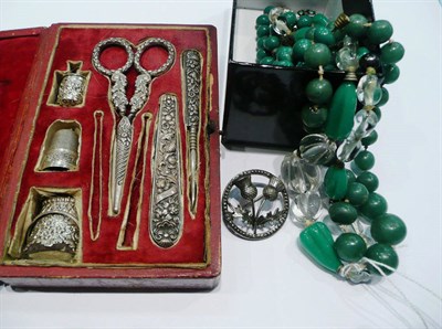 Lot 309 - A cased manicure set, a costume jewellery necklace, beads, clip earrings, brooches