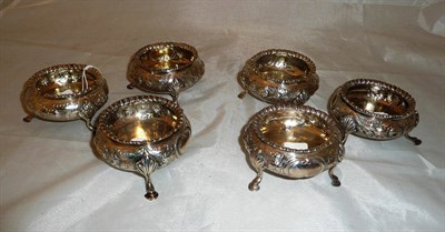 Lot 315 - A set of six Victorian silver embossed salts on hoof feet