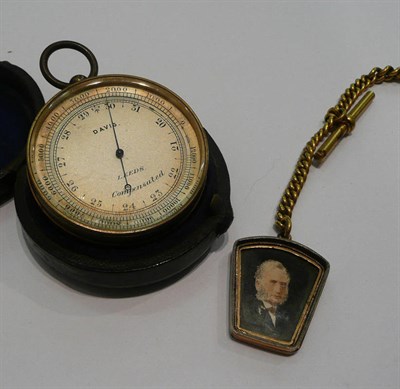 Lot 362 - A pocket barometer, metal chain and a portrait fob