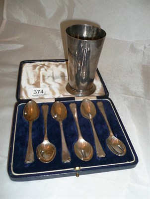 Lot 374 - A white metal cup and six silver teaspoons