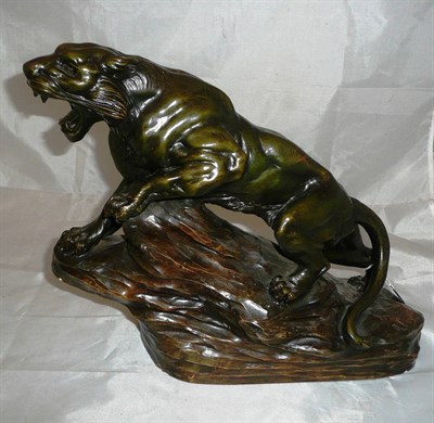 Lot 382 - A plaster figure of a tiger on rocky base with signature to base