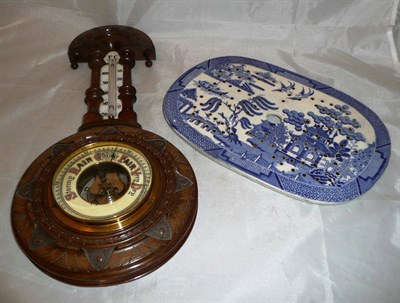 Lot 383 - A carved oak aneroid barometer and a Spode meat drainer