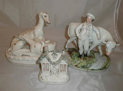 Lot 391 - A Staffordshire model of a farmer and cow and two other Staffordshire models