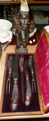 Lot 402 - A cased carving set with antler handles, a carved African fertility figure and a carved African...