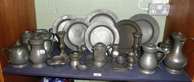 Lot 443 - A shelf of pewter including six 18th century plates, tankards, candlesticks, baluster measures,...