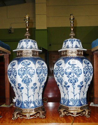 Lot 483 - A pair of Delft style lamp bases with gilt mounts