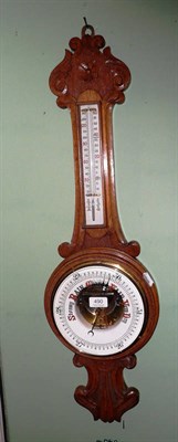 Lot 490 - A carved oak aneroid barometer