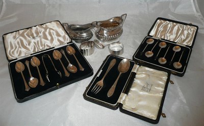 Lot 514 - Silver cream and sugar set, two napkin rings, sifter spoon, six teaspoons and tongs (cased),...