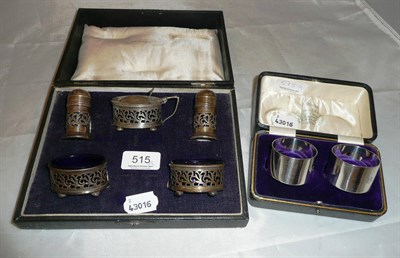 Lot 515 - Cased silver five pieces cruet set with blue glass liners and a pair of silver napkin rings (cased)