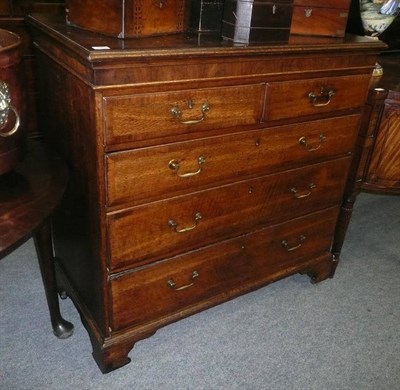 Lot 630 - A George III oak cross banded four height chest of drawers