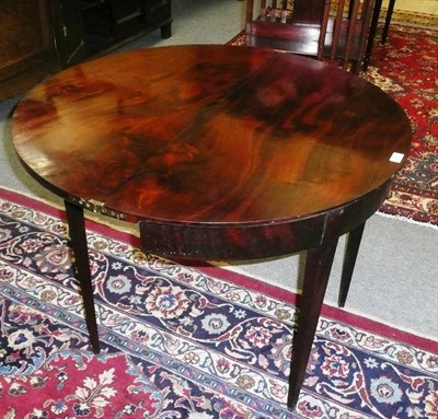 Lot 650 - A demi-lune mahogany fold over tea table