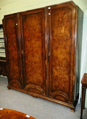 Lot 657 - Walnut three door wardrobe