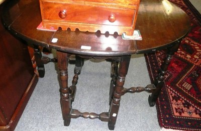 Lot 676 - An 18th century oak drop-leaf table