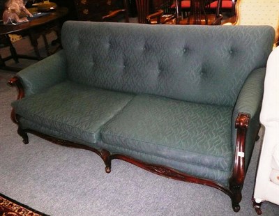 Lot 708 - A Victorian green upholstered sofa with carved mahogany frame