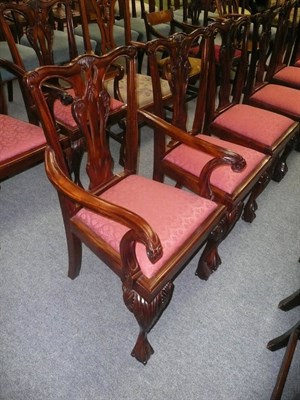 Lot 717 - A set of nine reproduction Chippendale style dining chairs, including two carvers