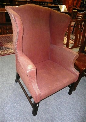 Lot 725 - A George III wingback armchair (restorations)