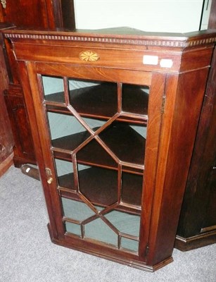 Lot 741 - A Georgian mahogany corner cupboard with glazed doors