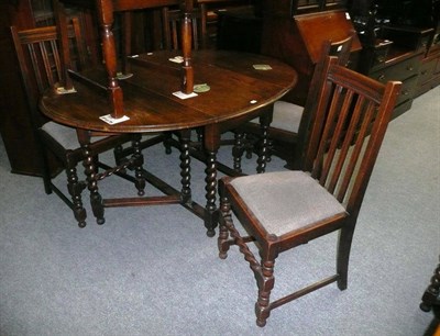 Lot 751 - A glazed oak display cabinet, a similar drop leaf table and five chairs