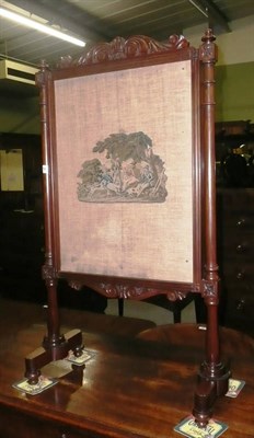 Lot 774 - A Victorian fire screen with needlework panel