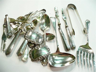 Lot 21 - A pair of silver sugar nips, three silver spirit labels, silver flatware, plated ware, etc